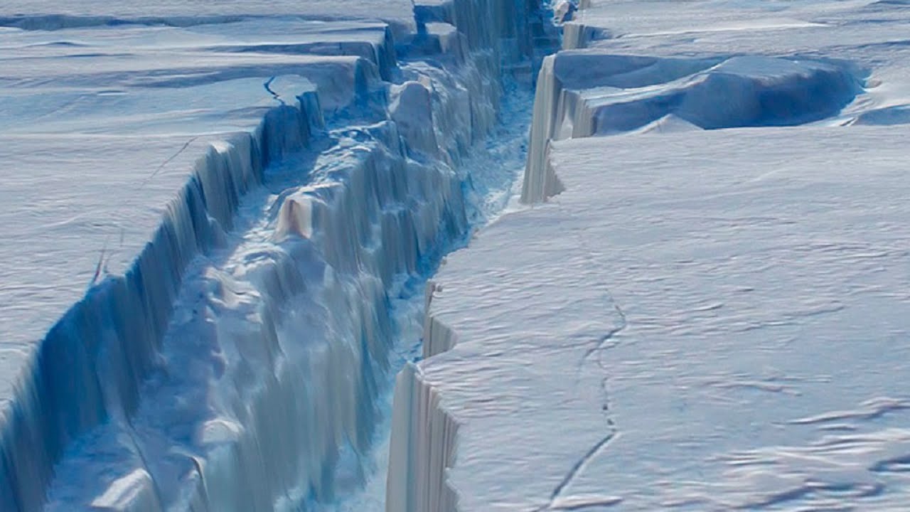 A white and blue photo showing the deep crack in the Antarctic ice shelf. white snow
blue and white crack